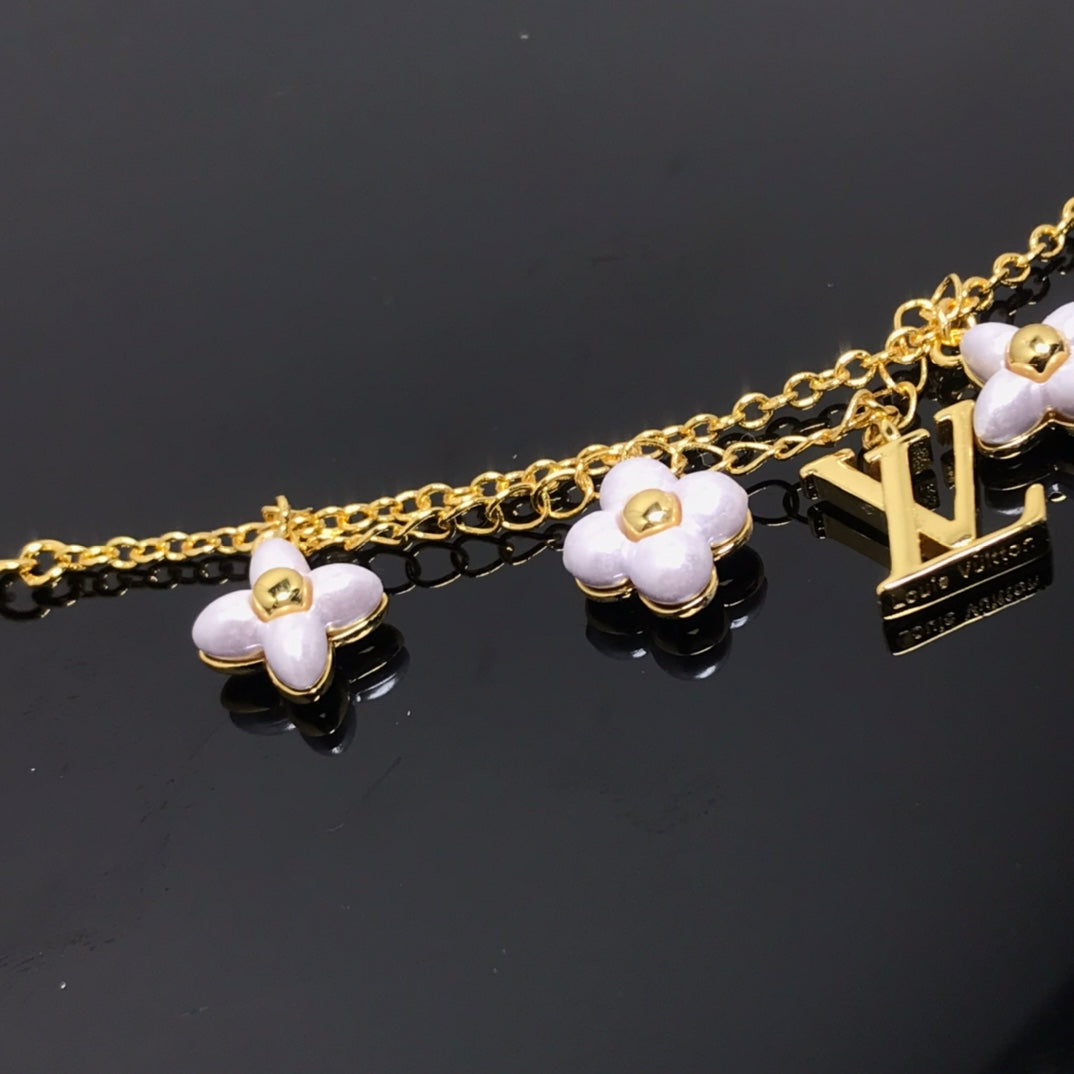 Aura LOGO 6 MOTIF STAR AND SUN GOLD BRACELET